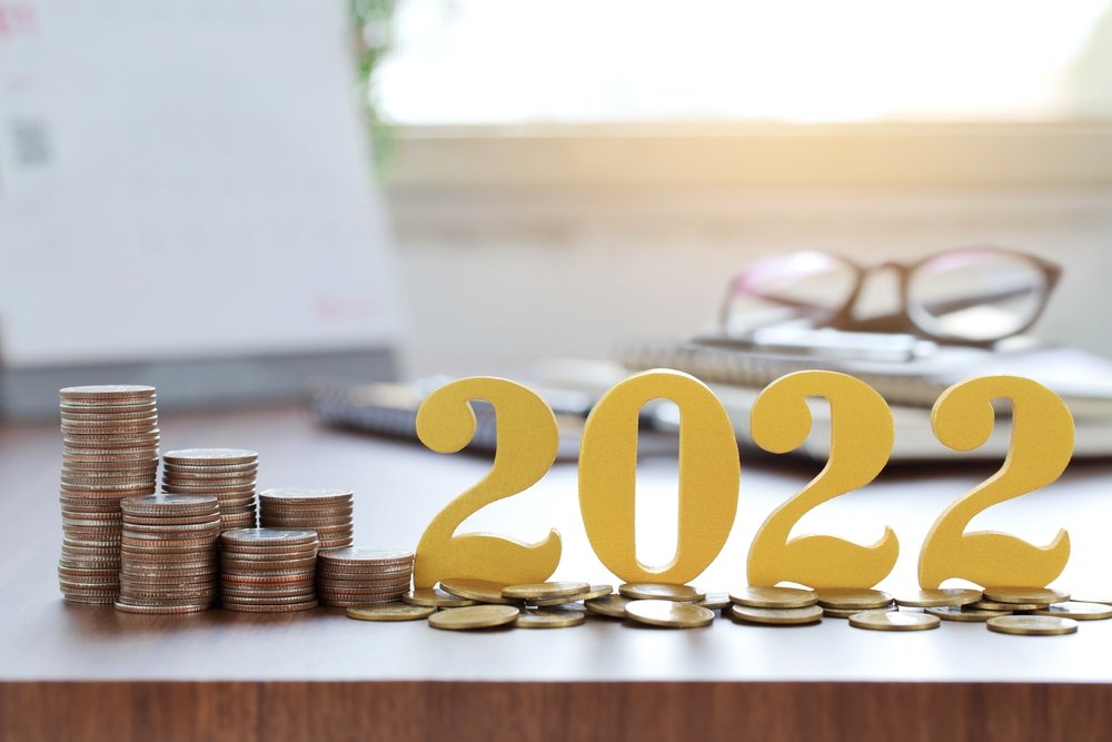coins stacked on a desk with big numbers sat next to them saying '2022'